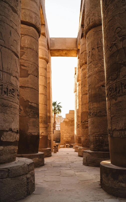 a stone structure with three large columns leading into the distance