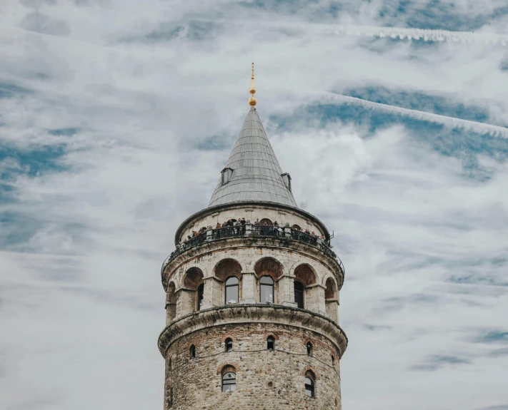 a tower with a sky background with planes in the background