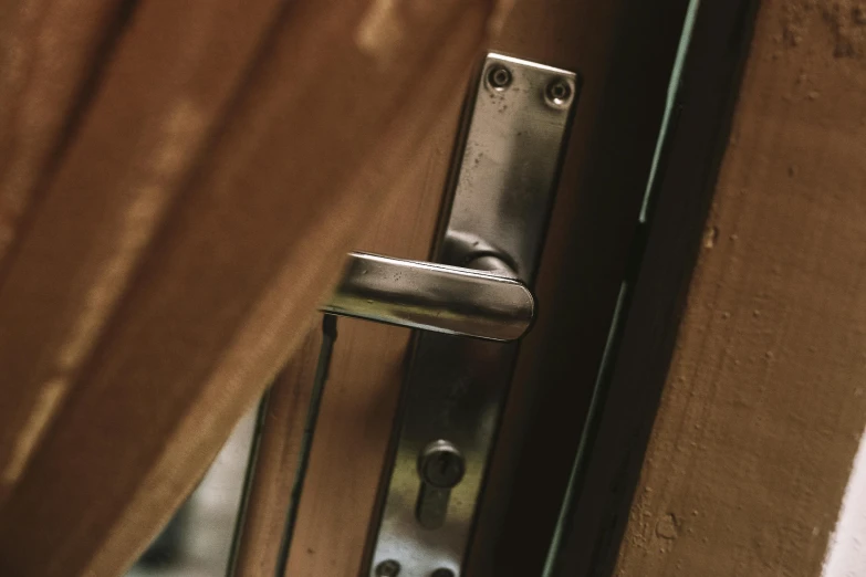 a close up of a door lock and curtain