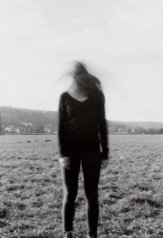 a woman is standing on the field with her back to the camera