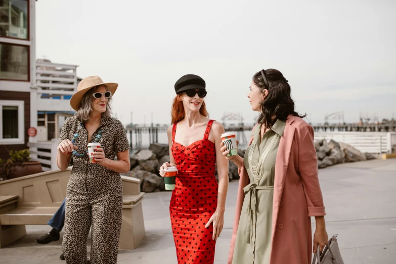 three women are laughing and talking on the beach