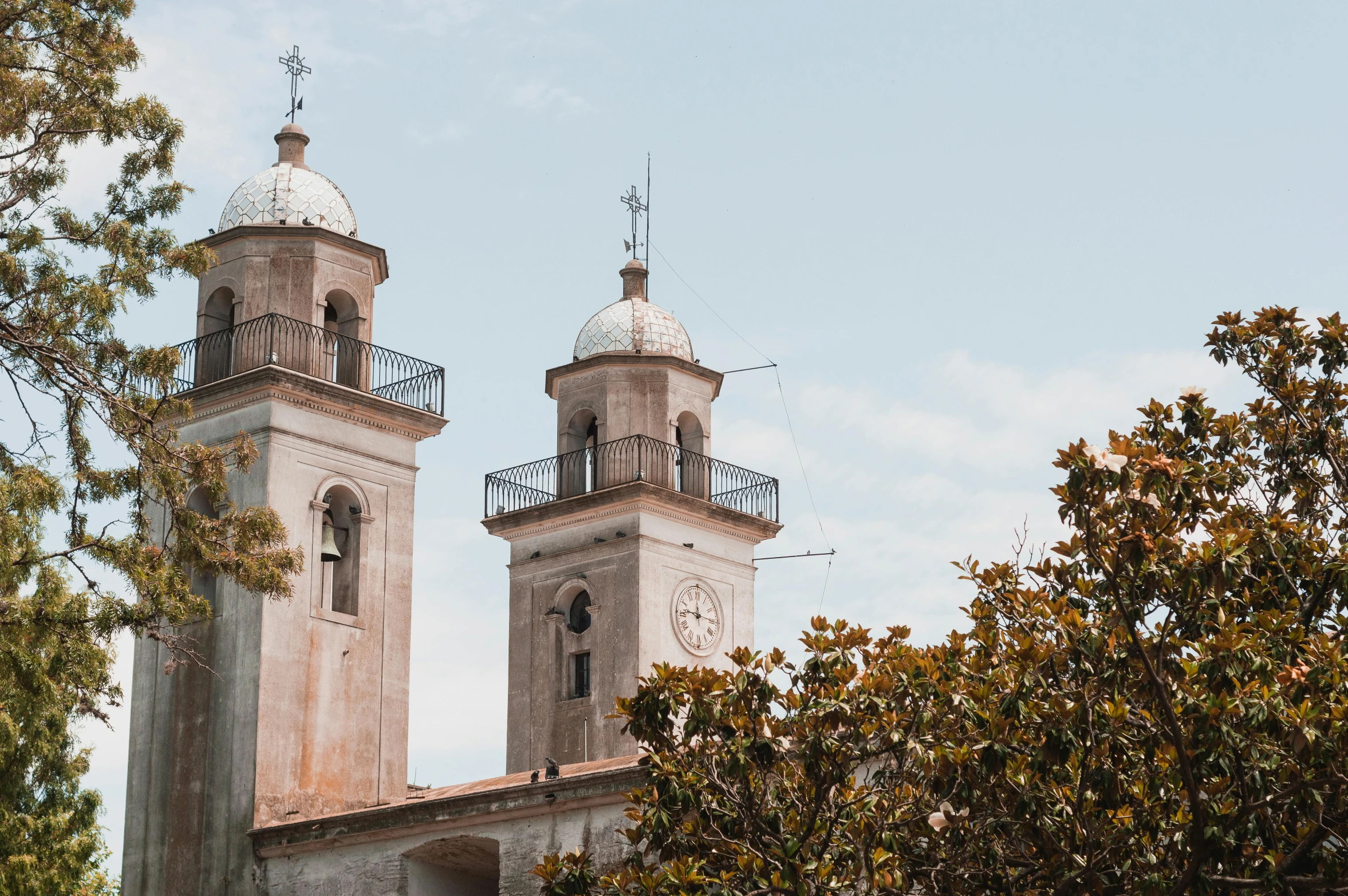 two towers with crosses and windows, with sky in background