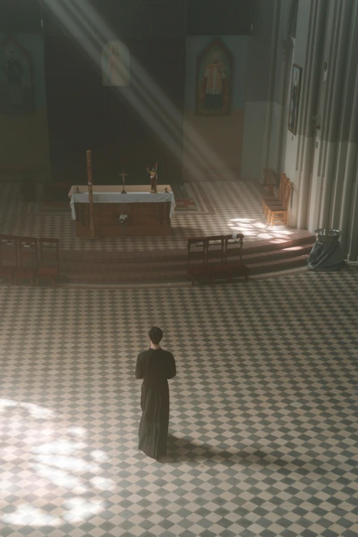 a man with a coat in front of a church altar