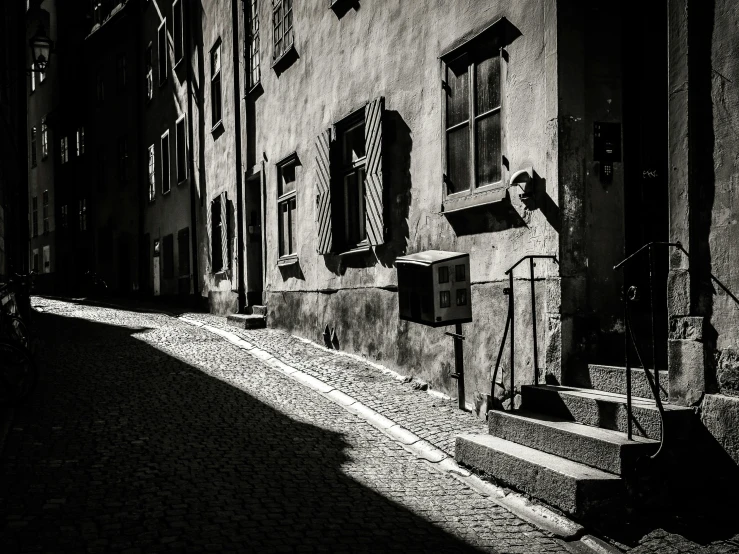 a street with cobblestone streets and tall buildings