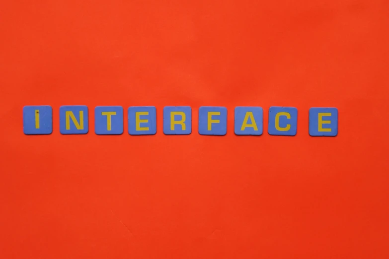 word written with blue plastic blocks on a red background