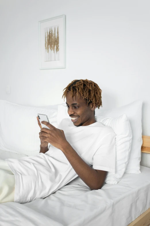 an image of a person lying down on bed with cellphone