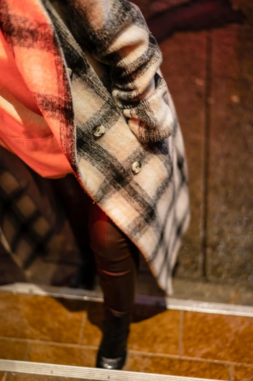 a picture of a woman's foot as she walks down the sidewalk