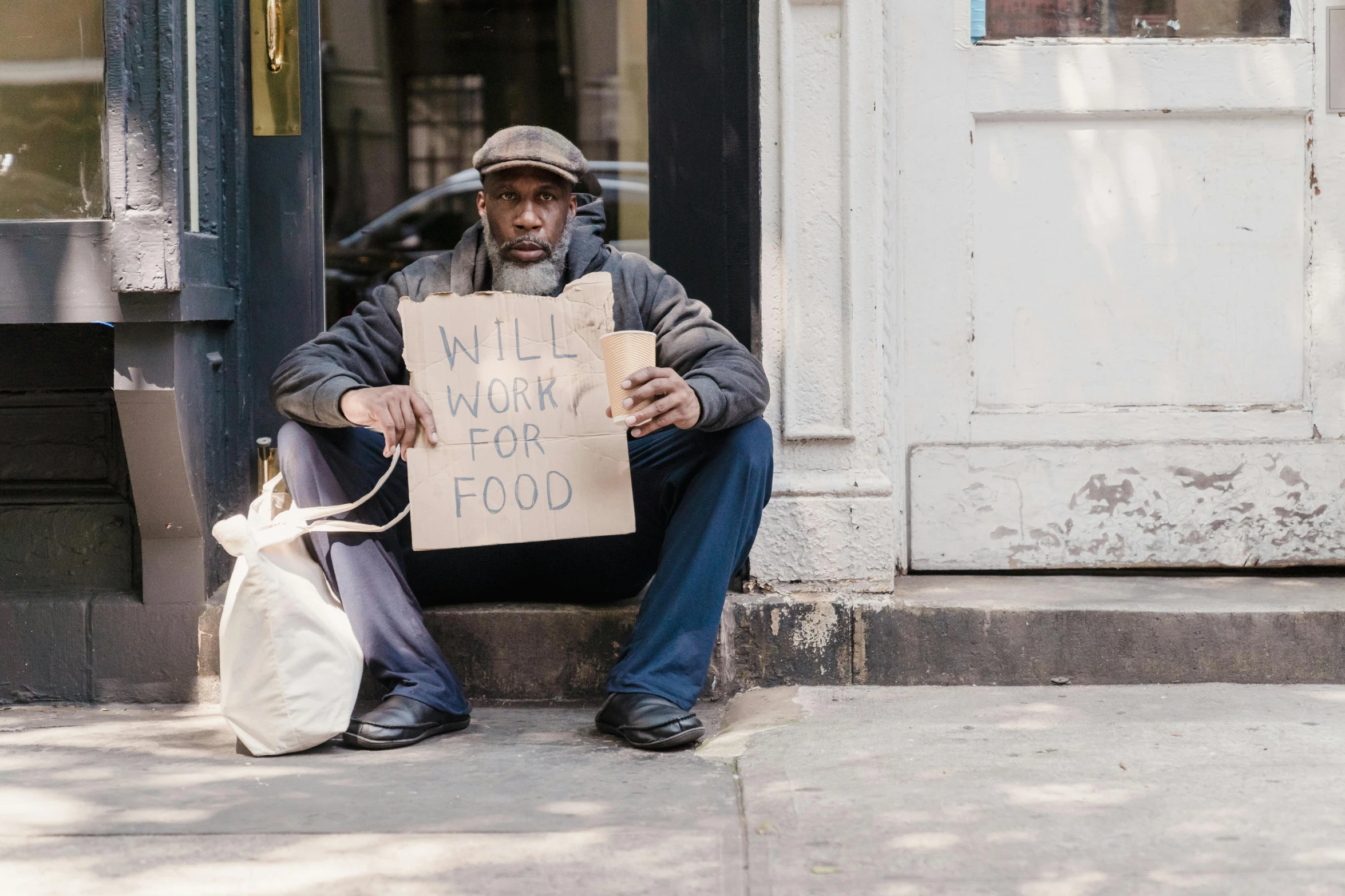 a man holds a sign outside a building