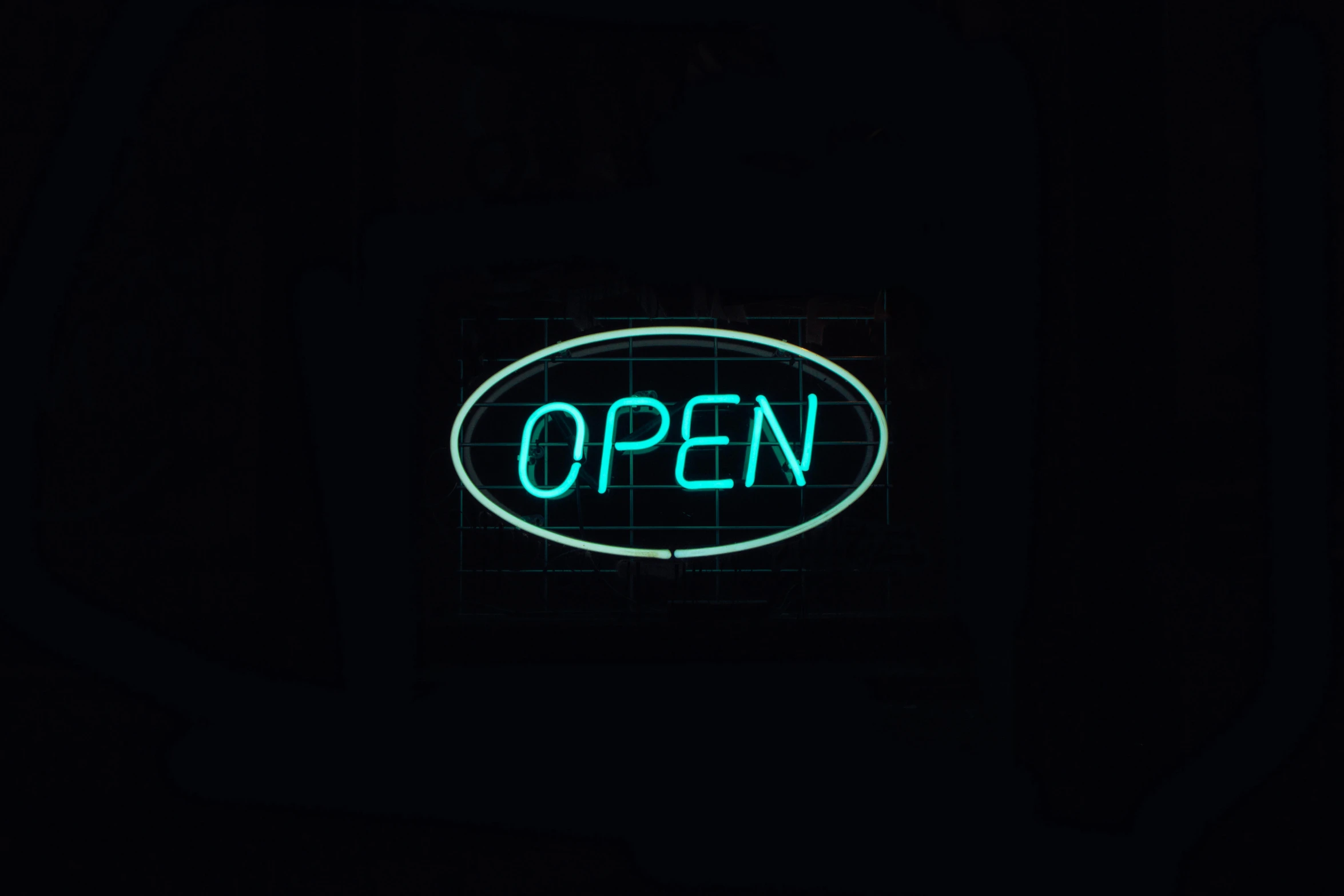 illuminated neon open sign on a dark background