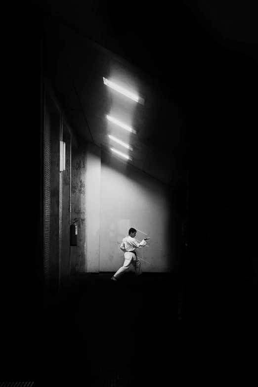 a man sitting on top of a chair in the dark