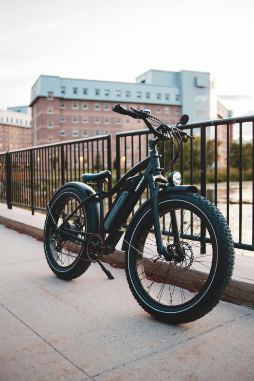 a blue bicycle is parked on a sidewalk