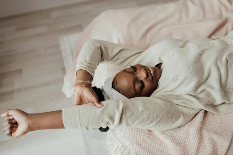 an african american woman is laying on a bed