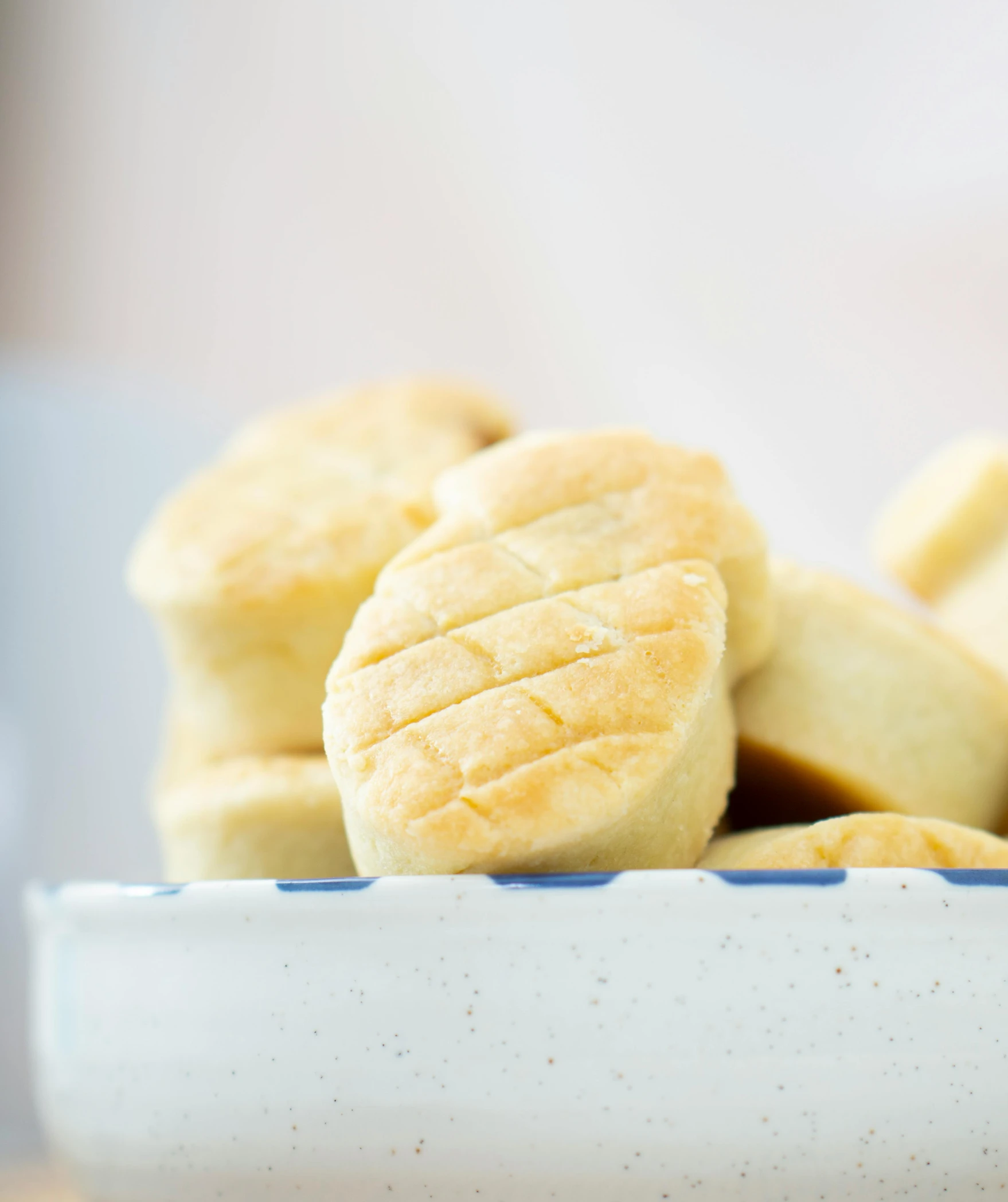 a white bowl filled with cut up pastries