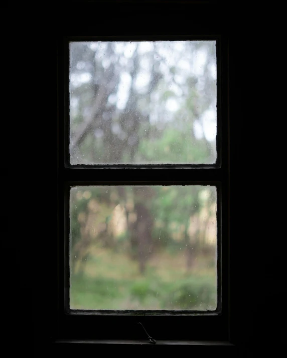 an open window with rain on the outside
