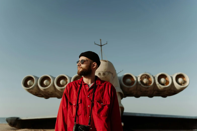 a man with a beard is standing in front of a decorative object