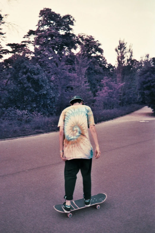 a man riding a skateboard down a street