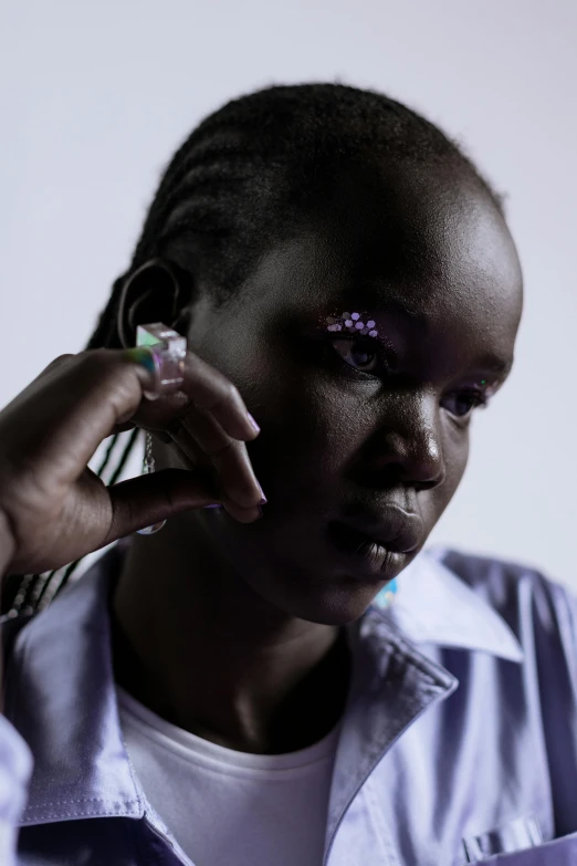 a woman wearing a pair of piercings putting on her face