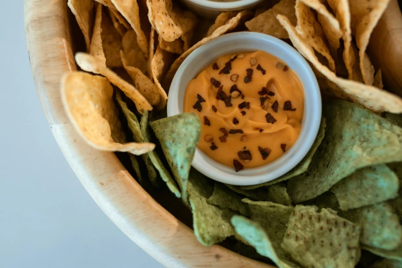 chips and dip in a wooden bowl on a counter