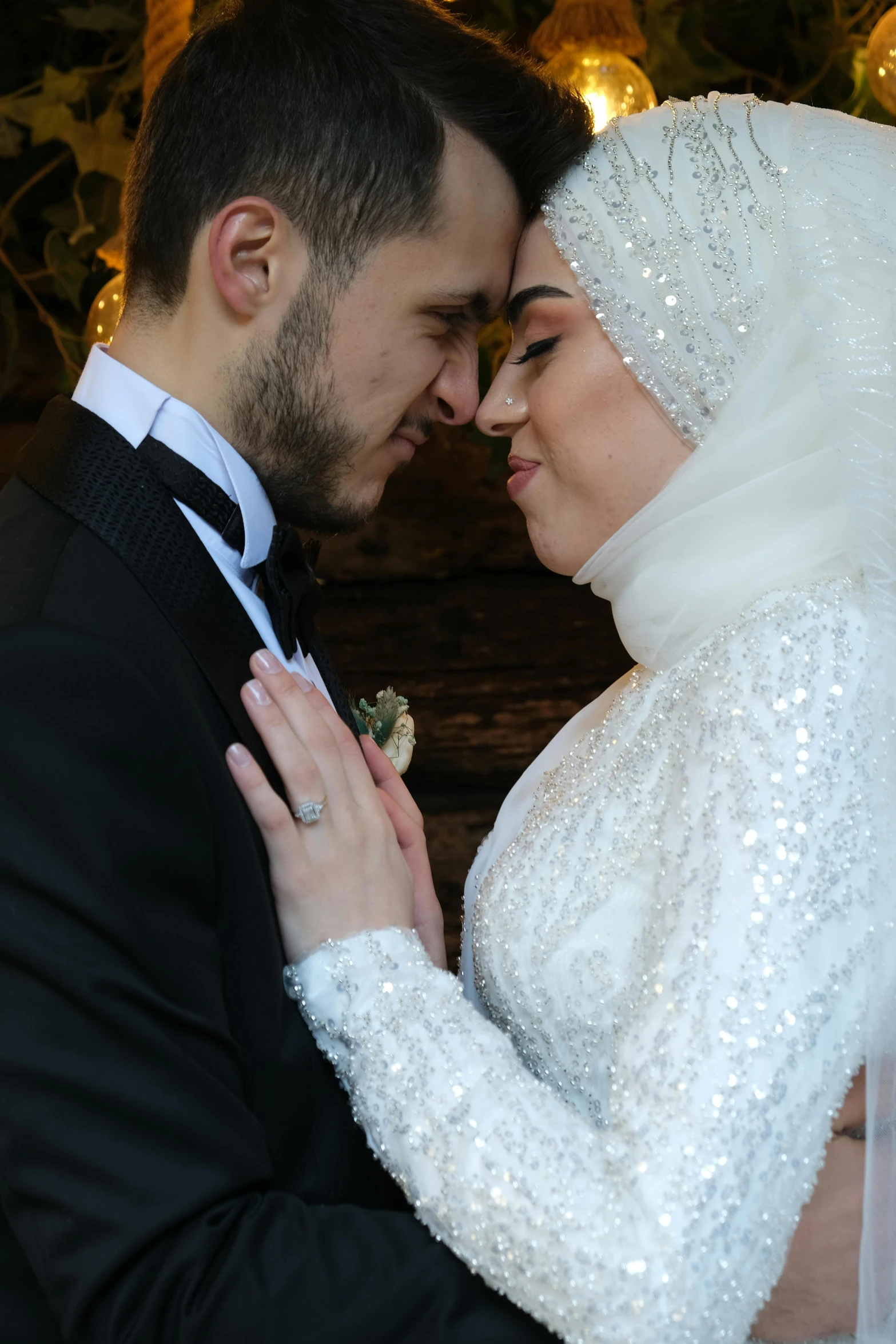 a couple is dressed in white at their wedding