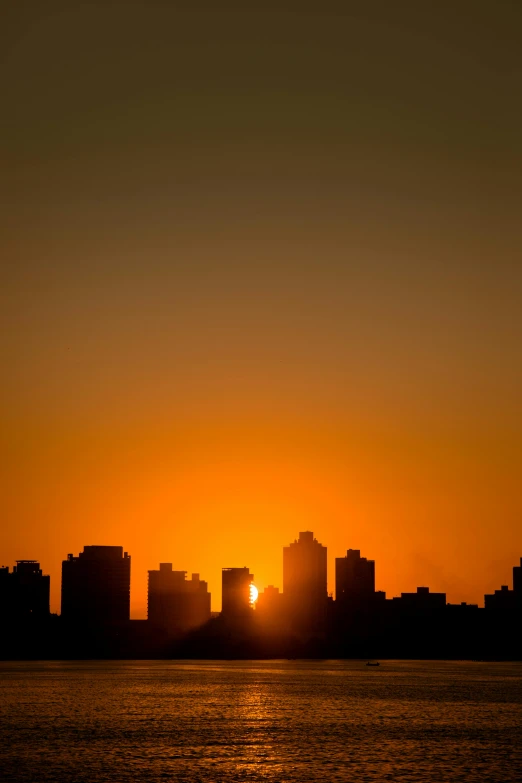 the sun is setting over an urban skyline