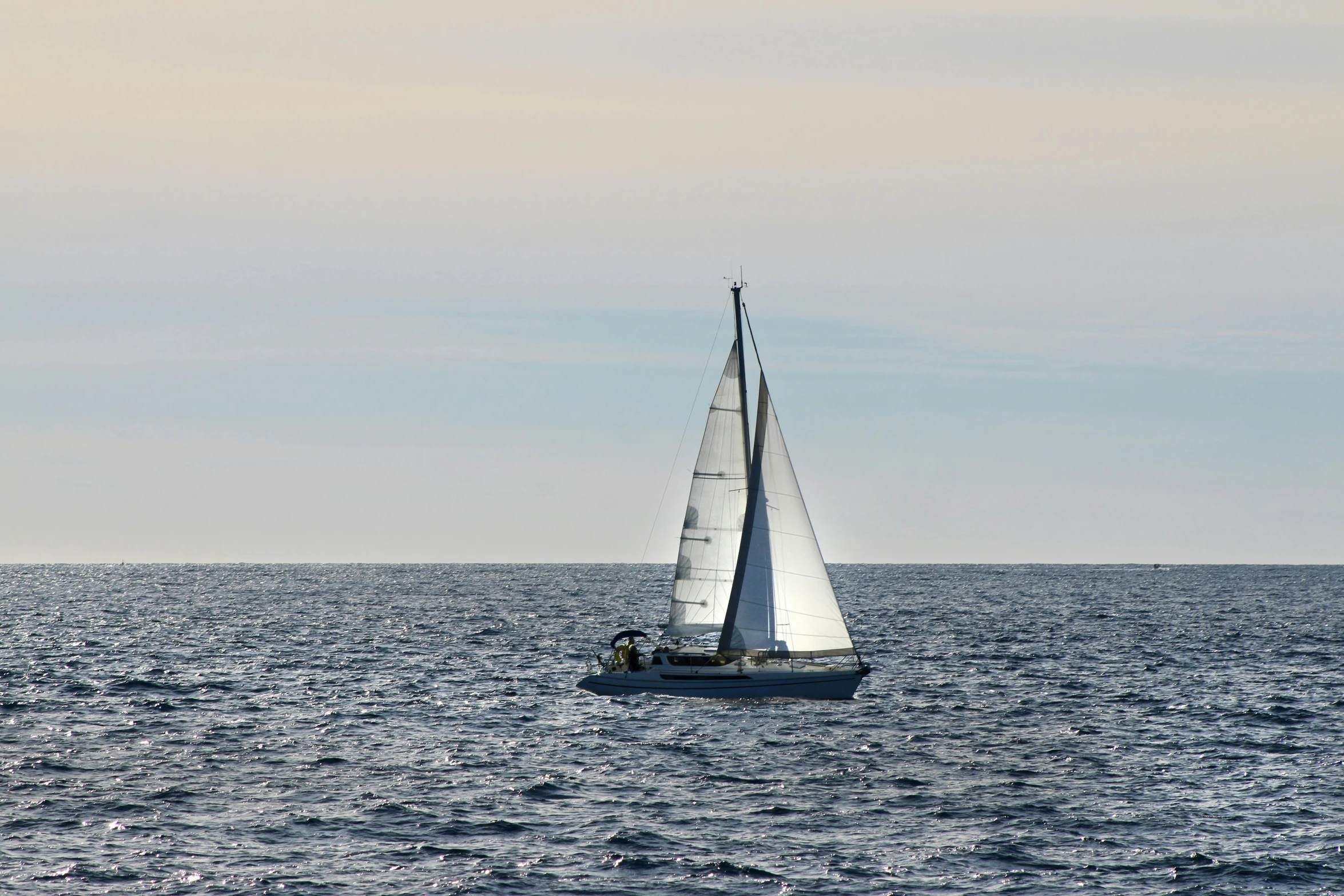 a sailboat sailing through a body of water