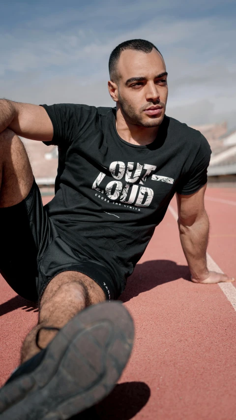 a man sitting down with his foot on the ground