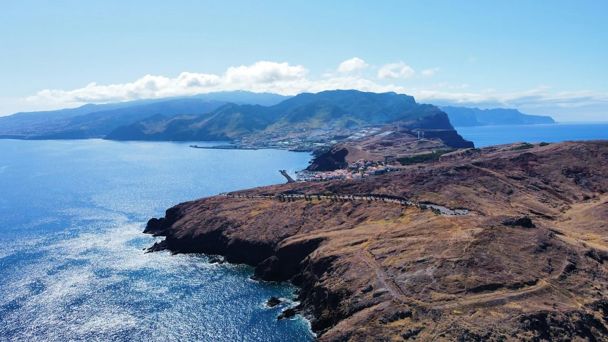 the aerial view of the coastline of a bay