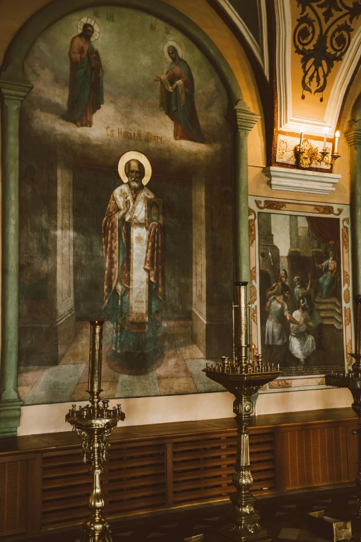 a painting and some candles inside of a church