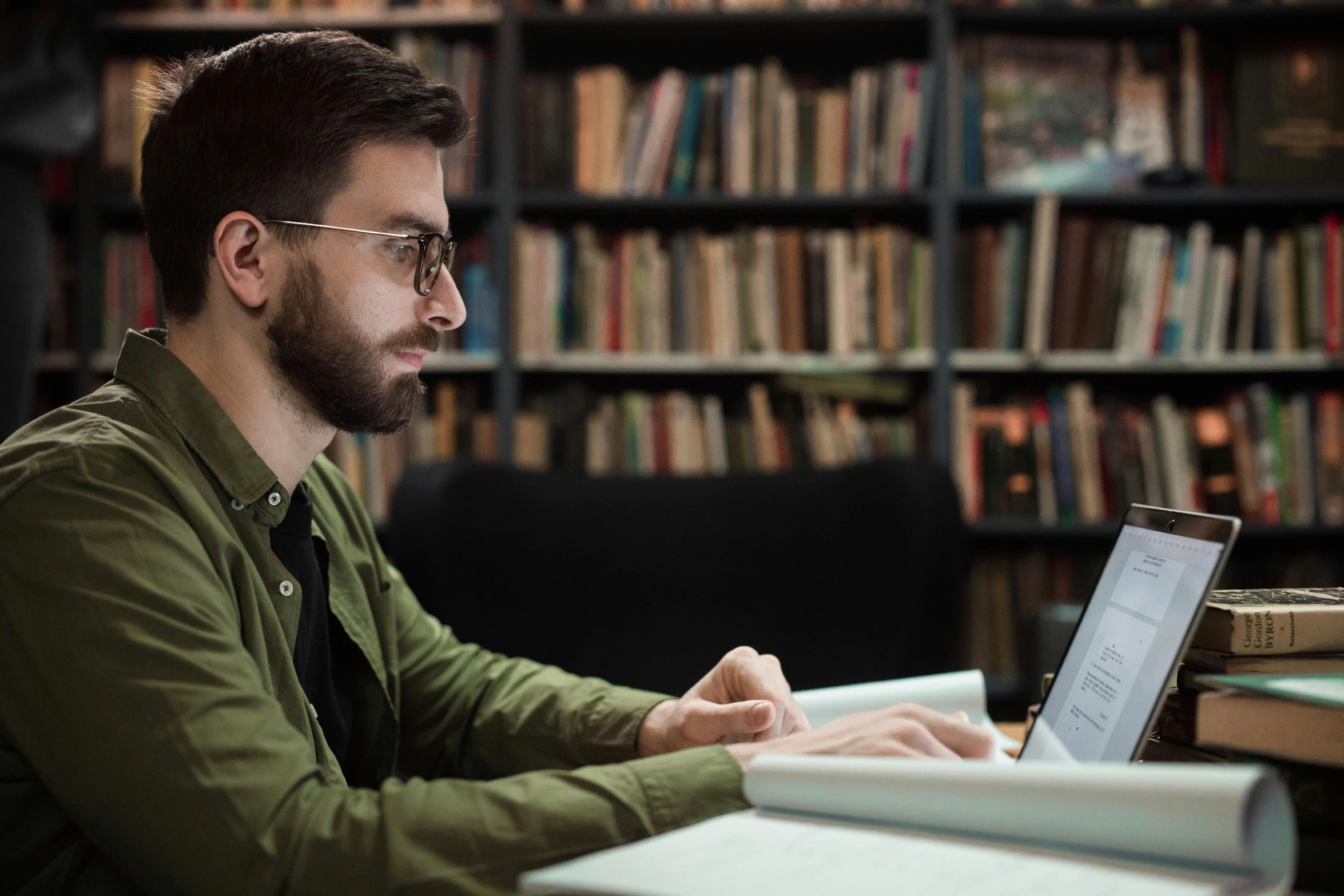 there is a man sitting at his desk on the computer