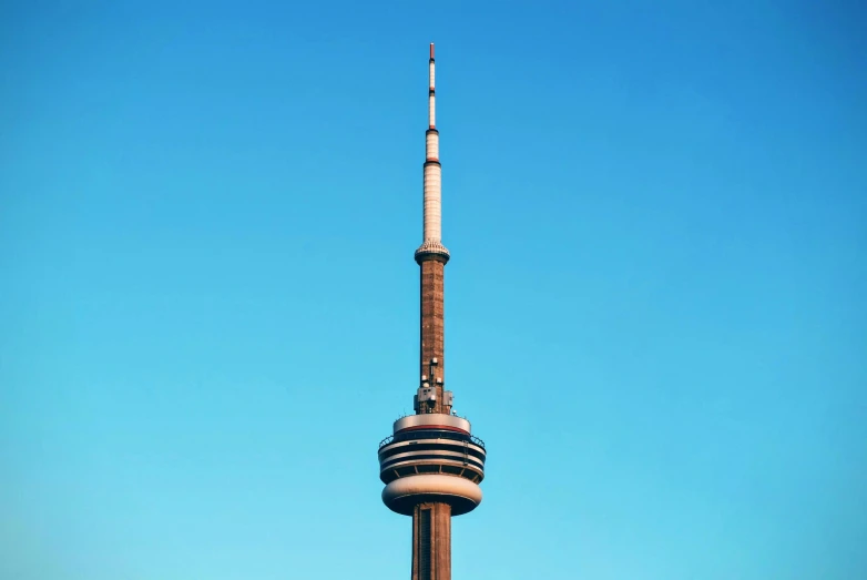 a tall building with a small metal spire on top