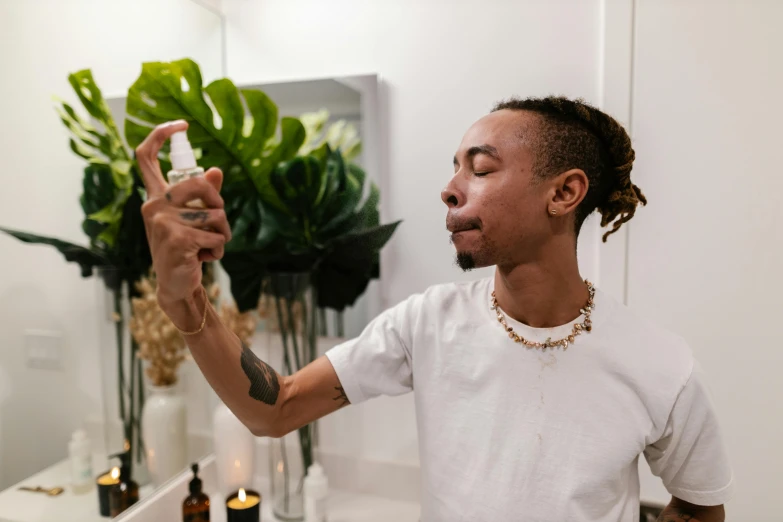 a man doing an up - do in front of the bathroom mirror