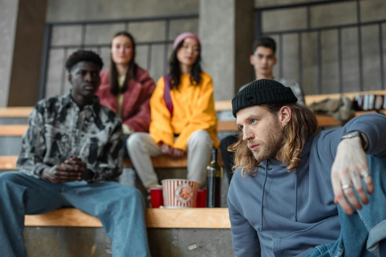 a group of young men and women sitting down