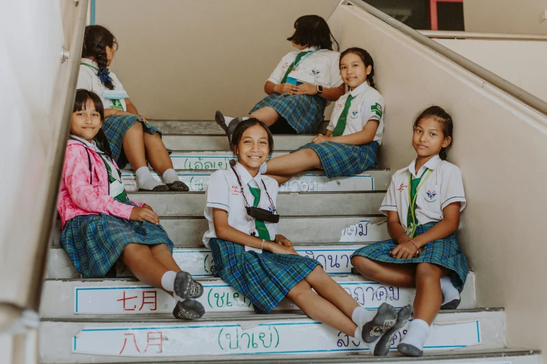 a group of girls sitting on top of stairs