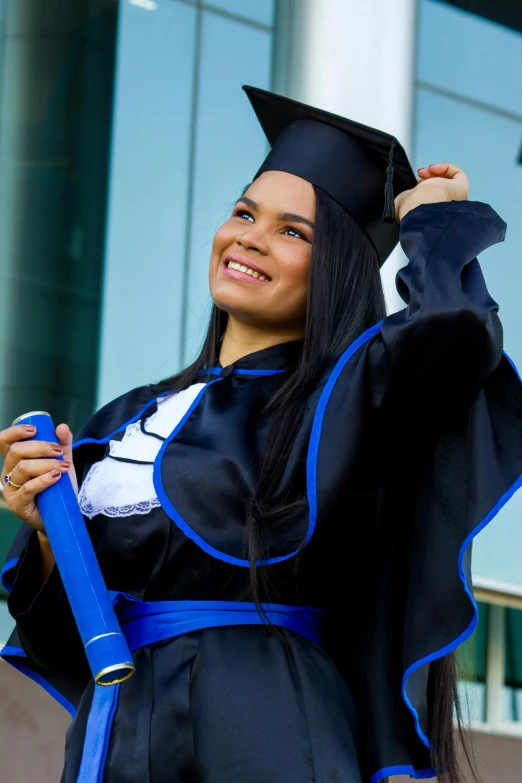 a smiling graduate wearing a graduation cap and gown