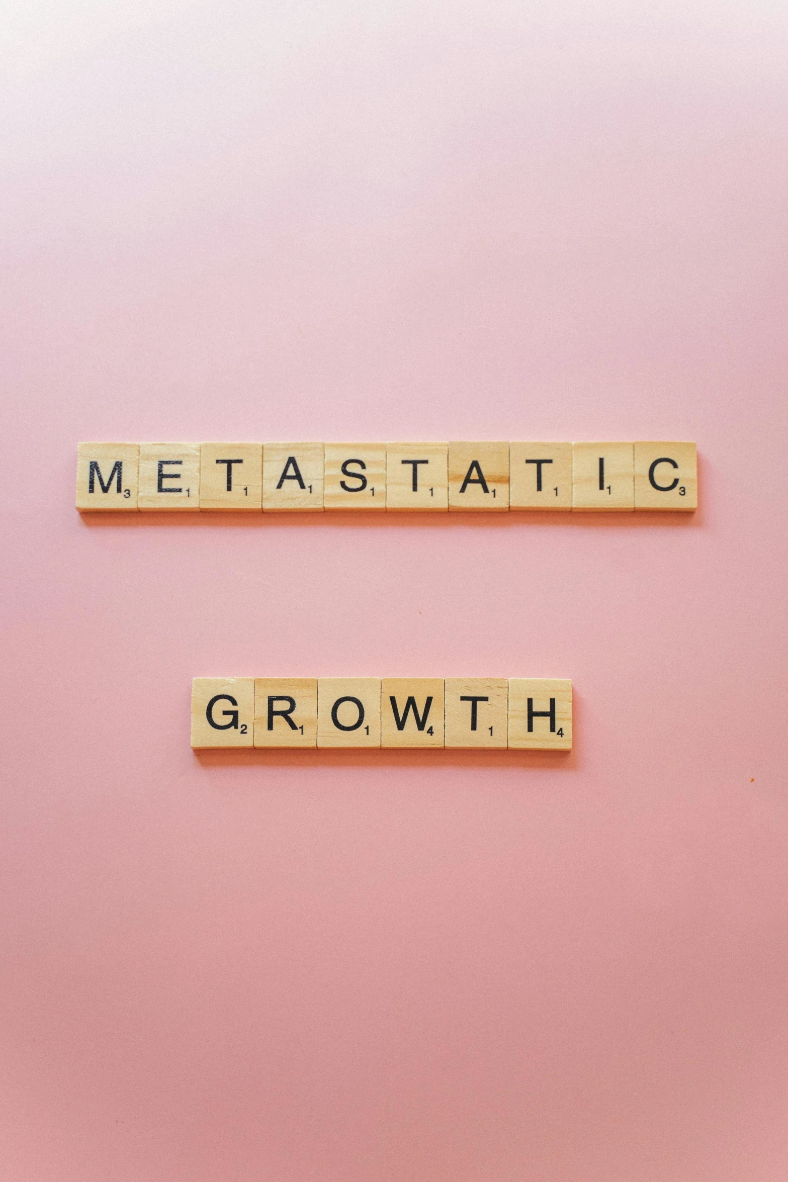 scrabbled type nameplates set against pink background