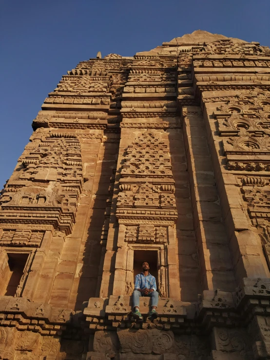 a woman is standing in the entrance to a very old building