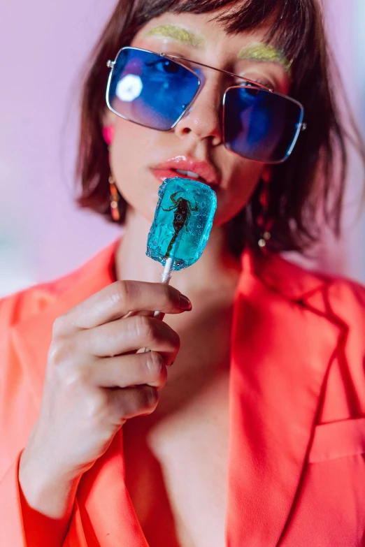 a woman with sunglasses holding onto a piece of food