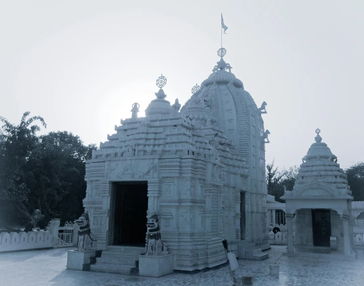 small white carved structure sitting on top of cement