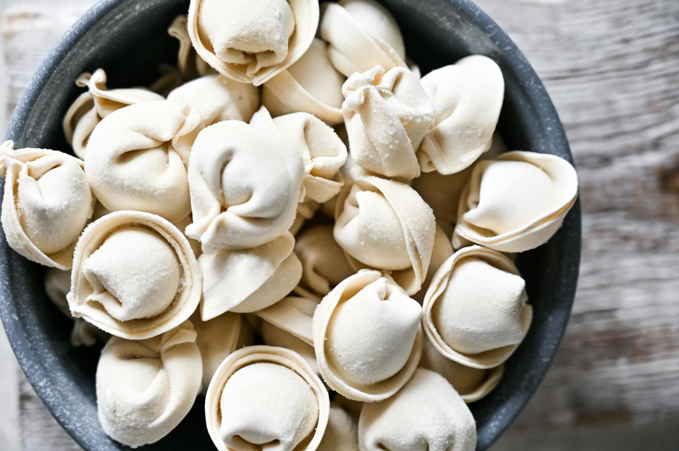 small white dumplings placed in a blue bowl