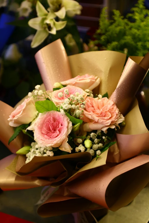 a bouquet of flowers is wrapped in brown paper