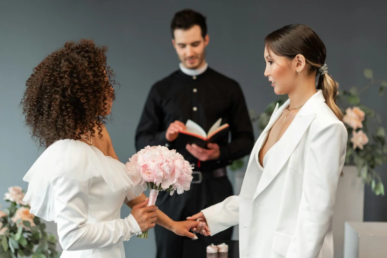 the bride and groom hold hands at their wedding ceremony