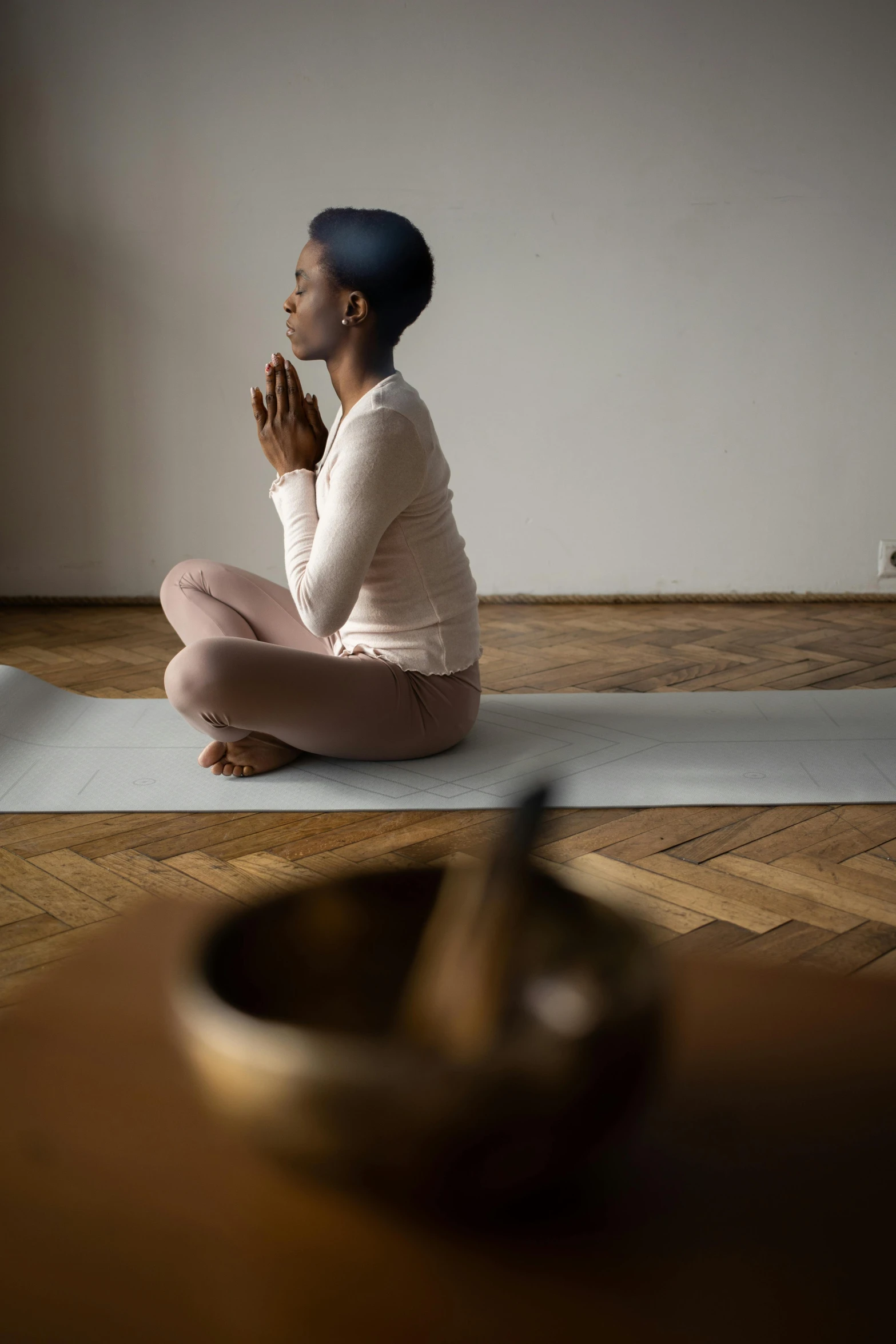 a woman doing a praying pose on the floor