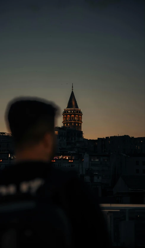 a man standing next to a very tall building