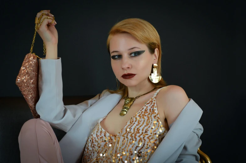 a woman posing with a big pair of earrings