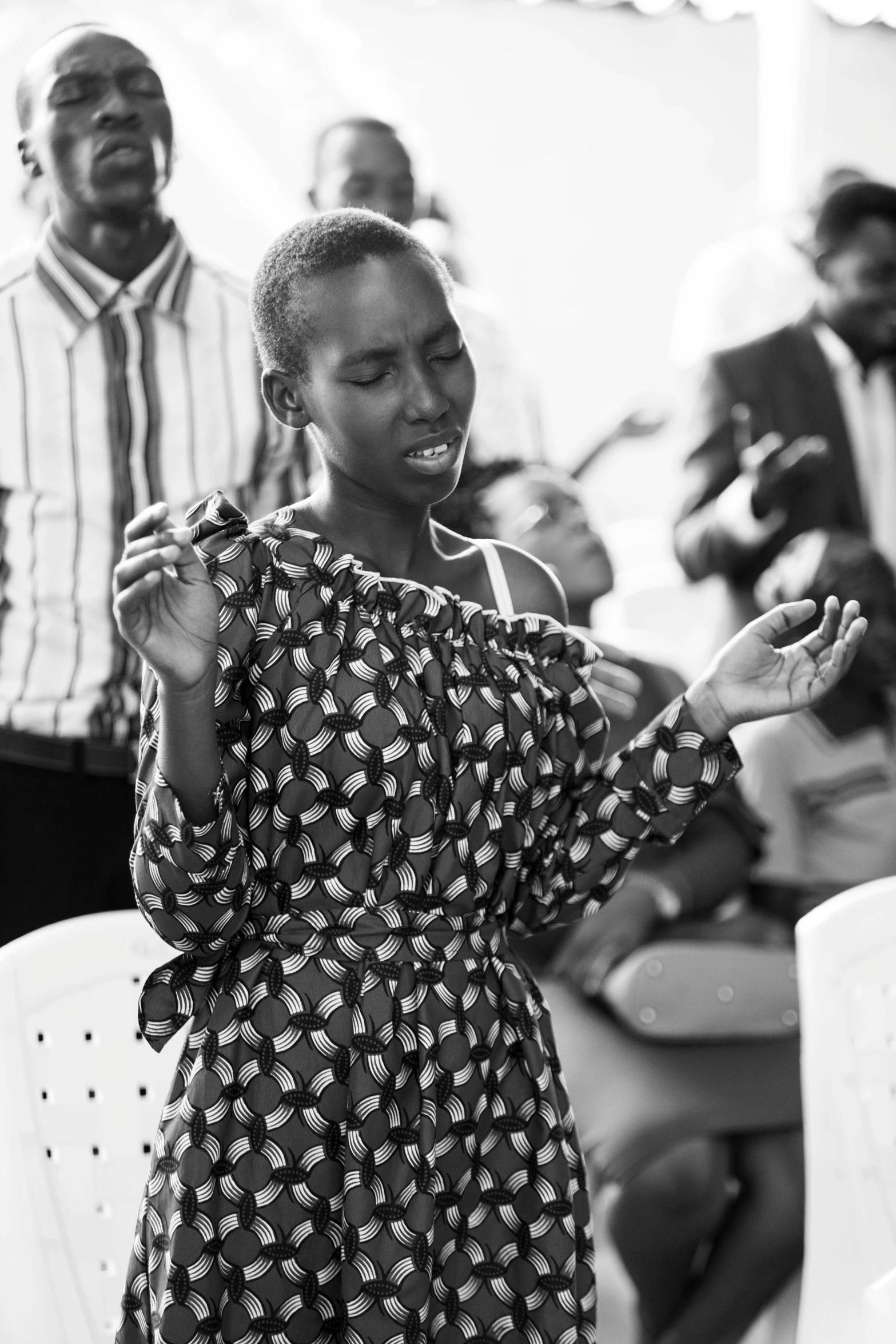 there is a woman standing and clapping in a group