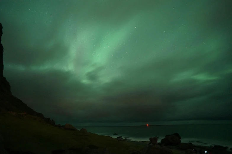 the sky is getting dark green and there are stars