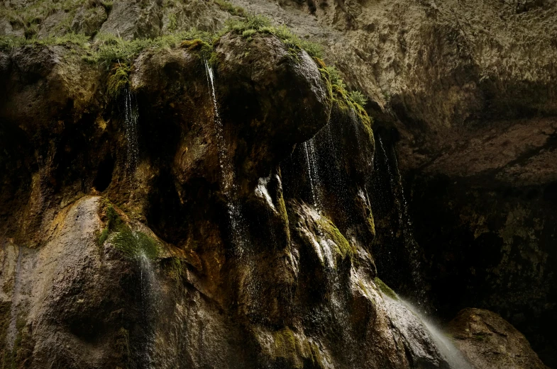 the image is of water running over a small mountain side