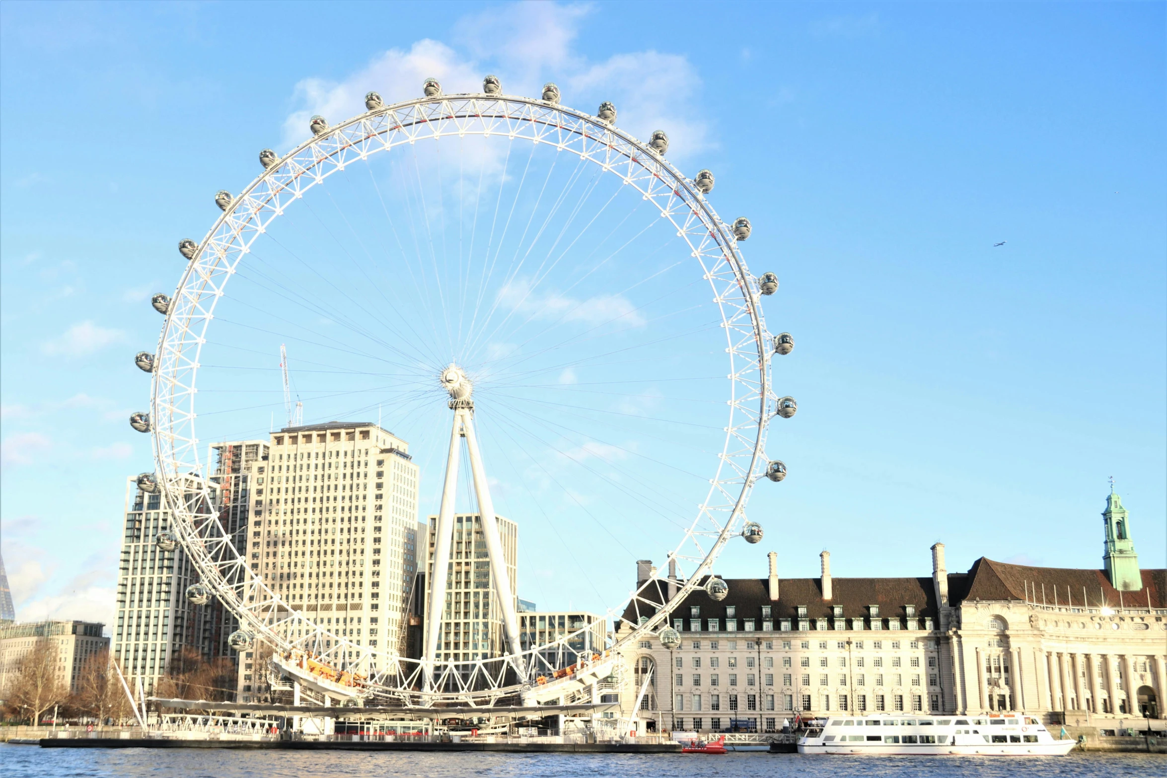 the big wheel is towering over a city