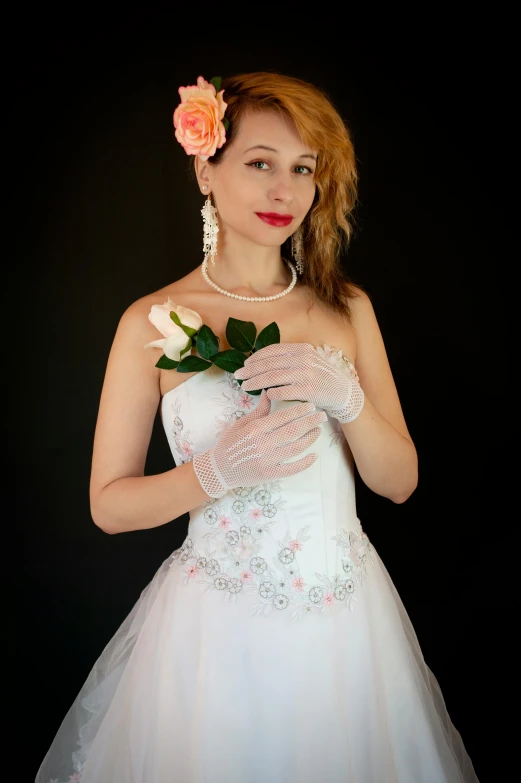 the woman is wearing her wedding dress and holding roses