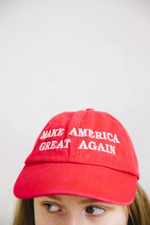 woman with red hat looking to the left, and white background